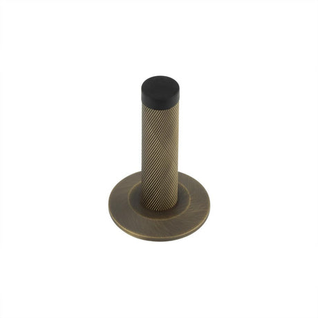 This is an image showing the Frelan - Burlington Knurled Wall Mounted Doorstops Chamfered Rose Antique Brass available to order from Trade Door Handles in Kendal