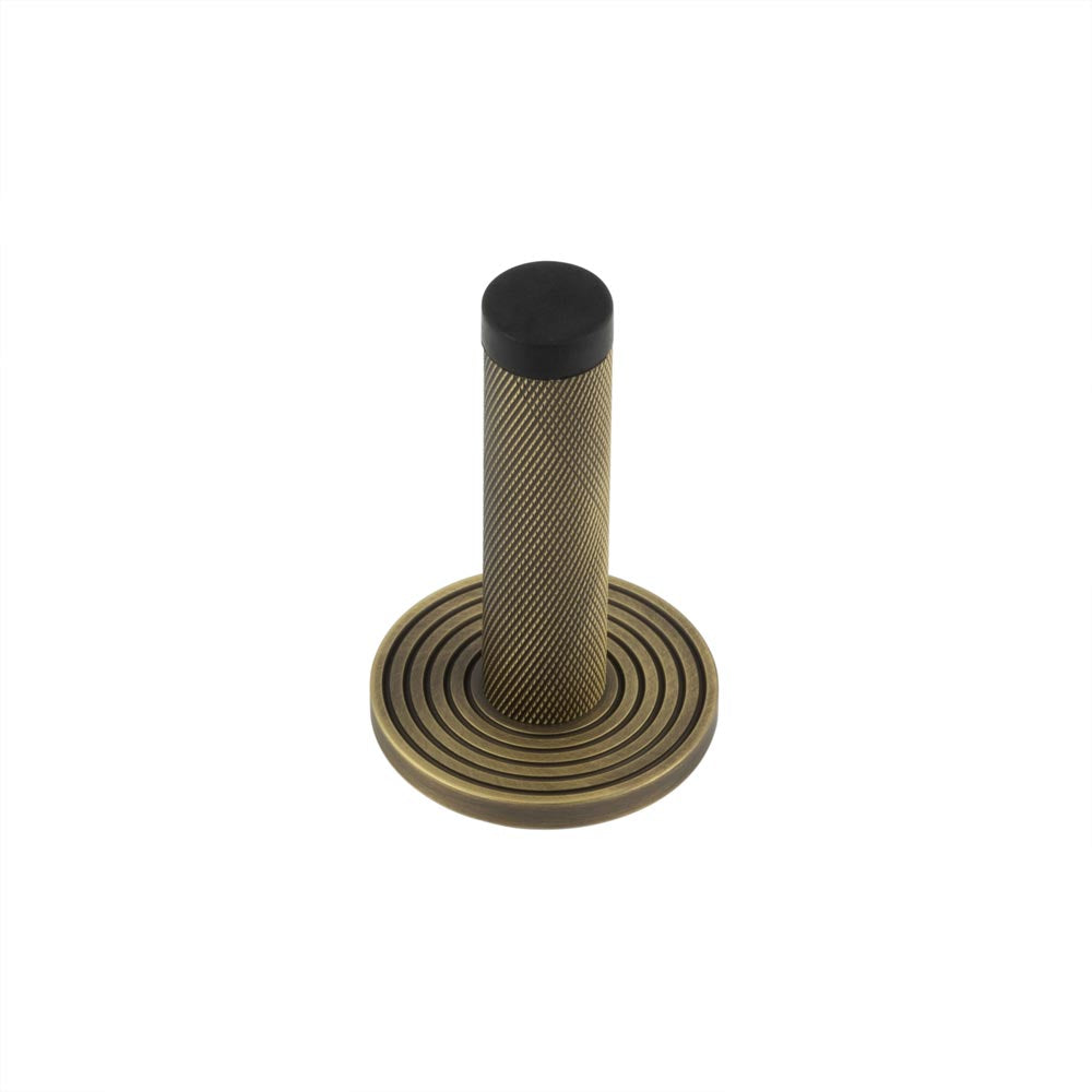 High quality image of Burlington - Knurled Wall Mounted Doorstops Reeded Rose Antique Brass Sku. BUR-968AB-974AB