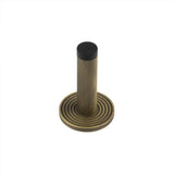 High quality image of Burlington - Knurled Wall Mounted Doorstops Reeded Rose Antique Brass Sku. BUR-968AB-974AB