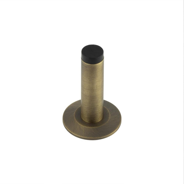 This is an image showing the Frelan - Burlington Plain Wall Mounted Door Stops Chamfered Rose Antique Brass available to order from Trade Door Handles in Kendal