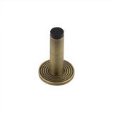High quality image of Burlington - Plain Wall Mounted Door Stops Reeded Rose Antique Brass Sku. BUR-970AB-974AB