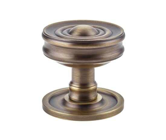 This is an image showing the Burlington - Bloomury Mortice knob - Antique Brass available to order from Trade Door Handles in Kendal