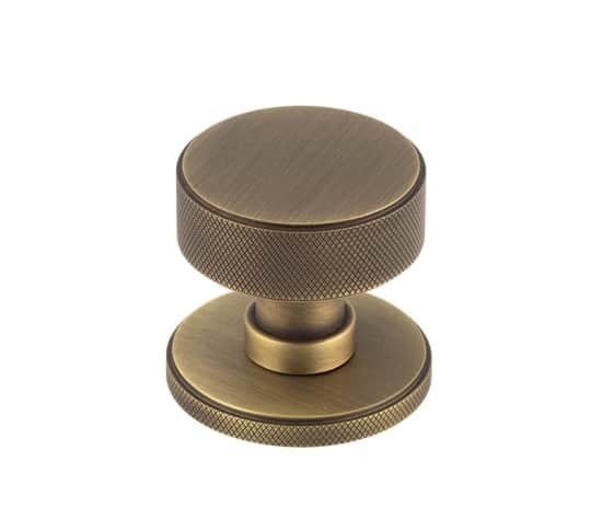 This is an image showing the Burlington - Antique Brass Westbourne Knurled Mortice Door Knob available to order from Trade Door Handles in Kendal