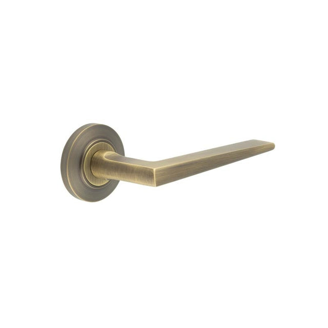 This is an image showing the Frelan - Mayfair Door Handle on Chamfered Rose Antique Brass available to order from Trade Door Handles in Kendal