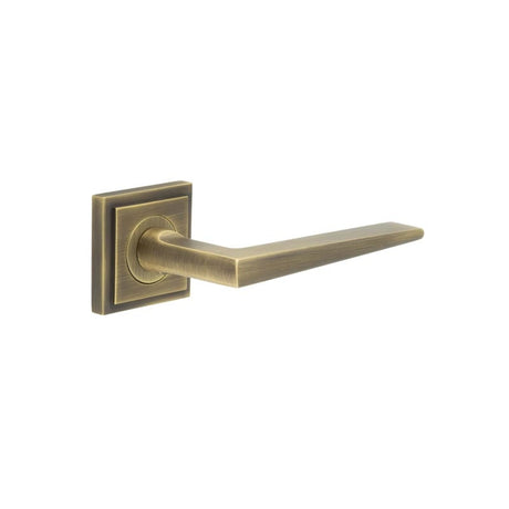 This is an image showing the Frelan - Mayfair Door Handle on Square Stepped Rose Antique Brass available to order from Trade Door Handles in Kendal