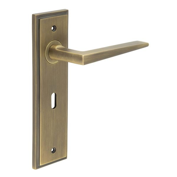 This is an image showing the Frelan - Mayfair Door Handle Lock Backplate Antique Brass available to order from Trade Door Handles in Kendal