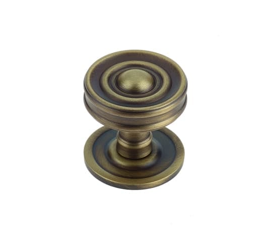 This is an image showing the Burlington - Bloomury cupboard knob - Antique Brass available to order from Trade Door Handles in Kendal