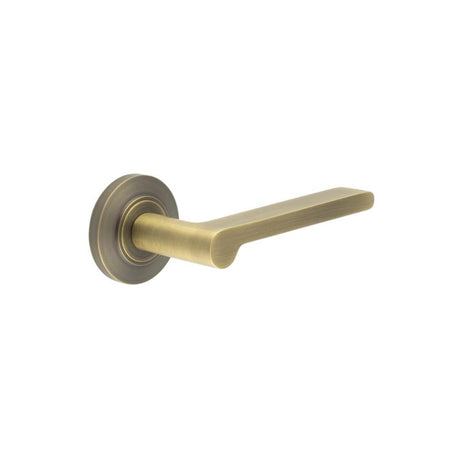 This is an image showing the Frelan - Fitzrovia Door Handles Chamfered Rose Antique Brass available to order from Trade Door Handles in Kendal