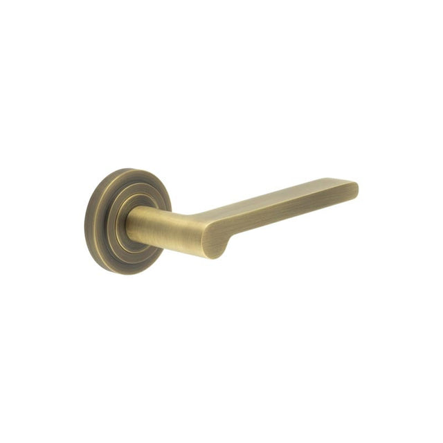 This is an image showing the Frelan - Fitzrovia Door Handles Stepped Rose Antique Brass available to order from Trade Door Handles in Kendal