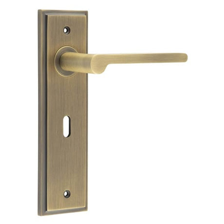 This is an image showing the Frelan - Fitzrovia Door Handle Lock Backplate Antique Brass available to order from Trade Door Handles in Kendal