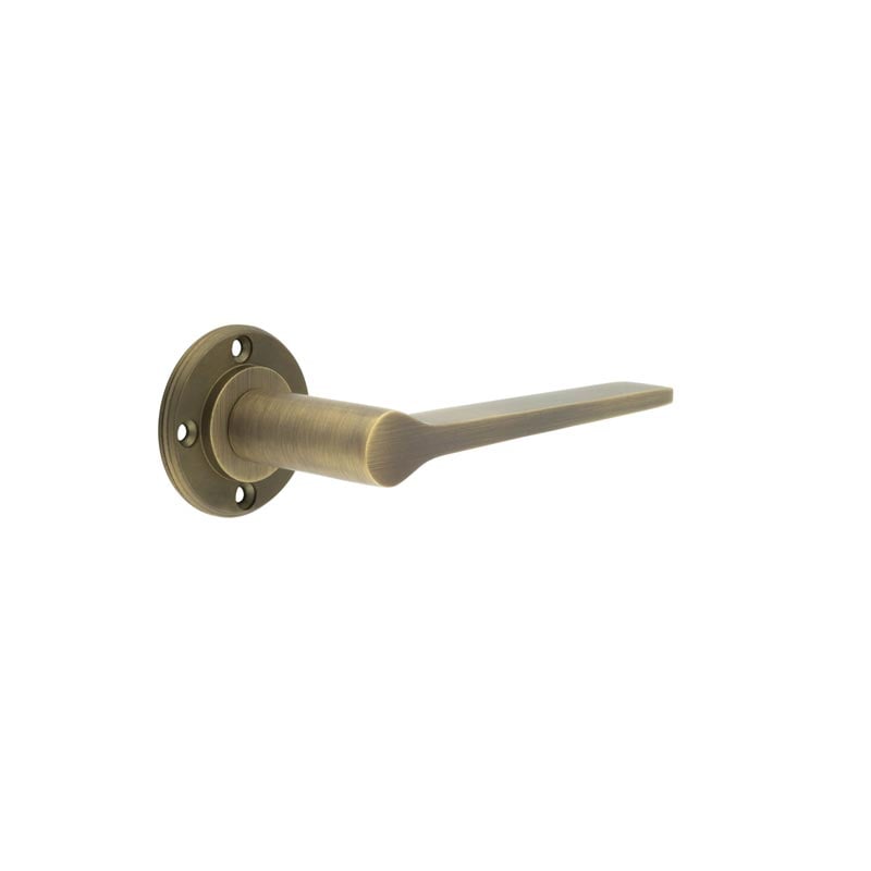 This is an image showing the Burlington - Knightsbridge lever on rose - Antique Brass available to order from Trade Door Handles in Kendal