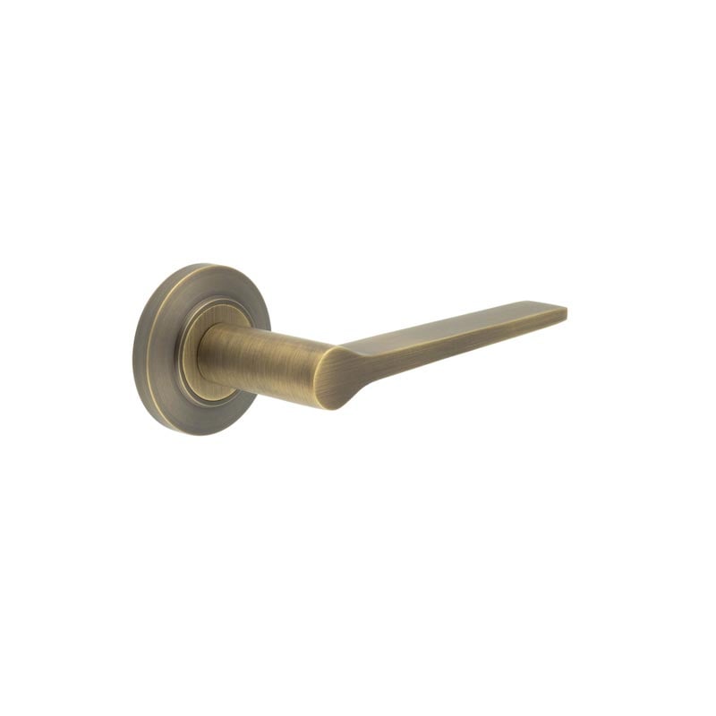 This is an image showing the Frelan - Knightsbridge Door Handle on Chamfered Rose Antique Brass available to order from Trade Door Handles in Kendal