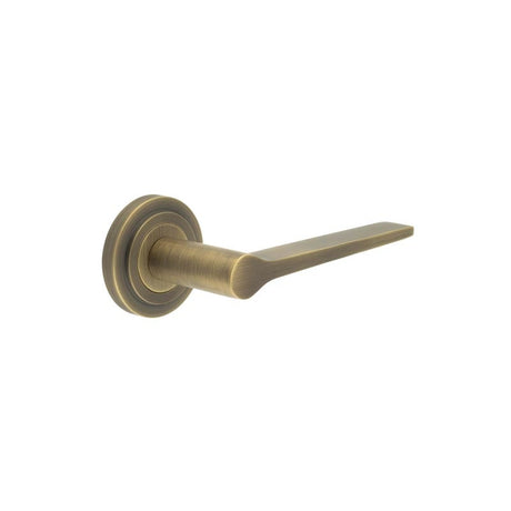 This is an image showing the Frelan - Knightsbridge Door Handle on Stepped Rose Antique Brass available to order from Trade Door Handles in Kendal