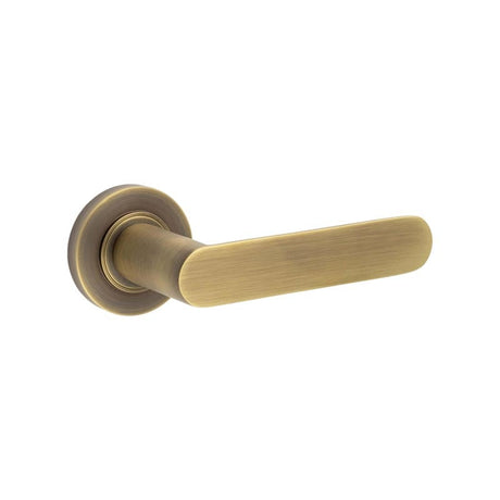 This is an image showing the Frelan - Kensington Door Handles Plain Rose Antique Brass available to order from Trade Door Handles in Kendal