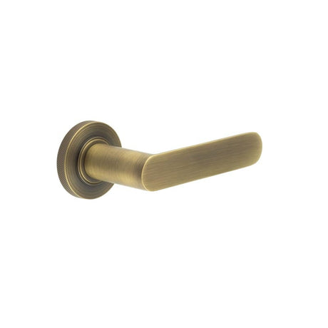 This is an image showing the Frelan - Kensington Door Handles Knurled Rose Antique Brass available to order from Trade Door Handles in Kendal