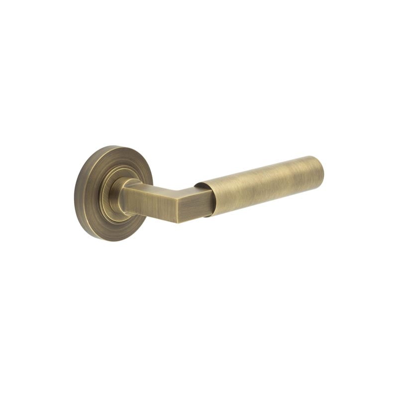 This is an image showing the Frelan - Westminster Door Handle on Plain Rose Antique Brass available to order from Trade Door Handles in Kendal