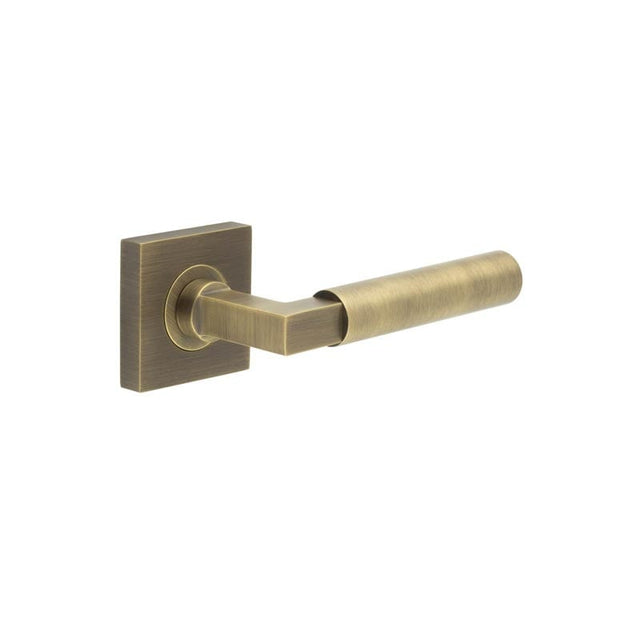 This is an image showing the Frelan - Westminster Door Handle on Square Plain Rose Antique Brass available to order from Trade Door Handles in Kendal