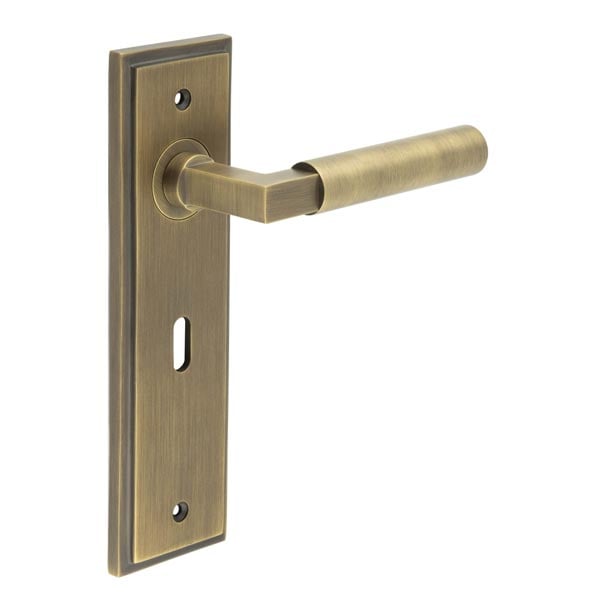 This is an image showing the Frelan - Westminster Door Handle Lock Backplate Antique Brass available to order from Trade Door Handles in Kendal