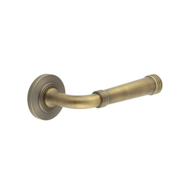 This is an image showing the Frelan - Highgate Door Handles Chamfered Rose Antique Brass available to order from Trade Door Handles in Kendal