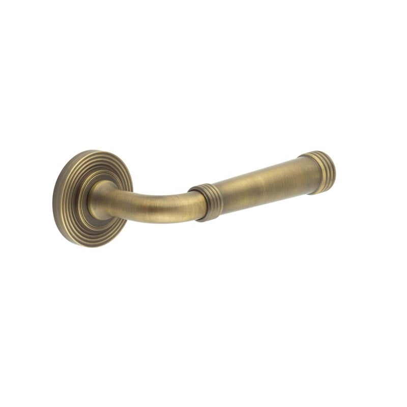 This is an image showing the Frelan - Highgate Door Handles Reeded Rose Antique Brass available to order from Trade Door Handles in Kendal