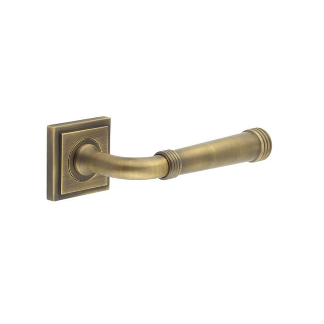 This is an image showing the Frelan - Highgate Door Handles Square Stepped Rose Antique Brass available to order from Trade Door Handles in Kendal