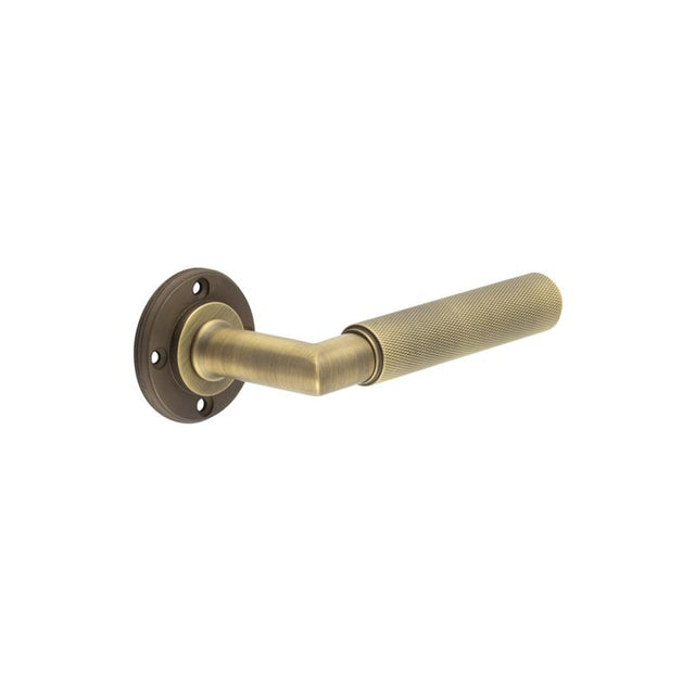 This is an image showing the Burlington - Piccadilly lever on rose - Antique Brass available to order from Trade Door Handles in Kendal