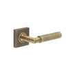 This is an image showing the Frelan - Piccadilly Door Handle on Square Plain Rose Antique Brass available to order from Trade Door Handles in Kendal