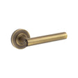 This is an image showing the Frelan - Richmond Door Handles Plain Rose Antique Brass available to order from Trade Door Handles in Kendal