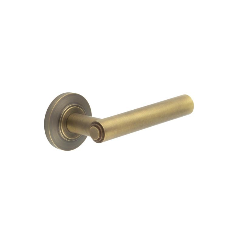 This is an image showing the Frelan - Richmond Door Handles Chamfered Rose Antique Brass available to order from Trade Door Handles in Kendal