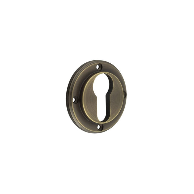 This is an image showing the Burlington - inner escutcheon euro - Antique Brass available to order from Trade Door Handles in Kendal