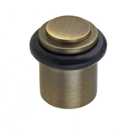 This is an image showing the Burlington - Floor mounted Door Stop - Antique Brass available to order from Trade Door Handles in Kendal