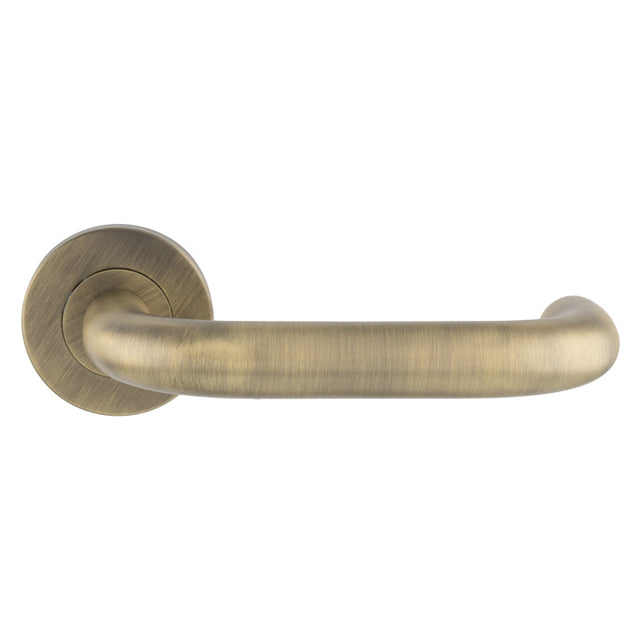 This is an image of Eurospec - Nera Safety Lever on Sprung Rose - Antique Brass - CSL1190AB available to order from Trade Door Handles in Kendal.