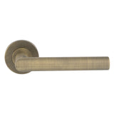 This is an image of Eurospec - Mitred Round Bar Lever on Sprung Rose - Antique Brass - CSL1192AB available to order from Trade Door Handles in Kendal.