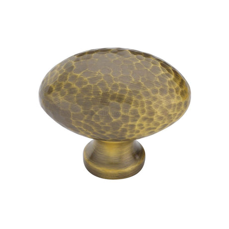 High quality image of Heritage Brass - Cabinet Knob Victorian Oval Hammered Design 38mm Antique Brass finish | Sku. ham114-38-at | available to order from Trade Door Handles in Kendal.