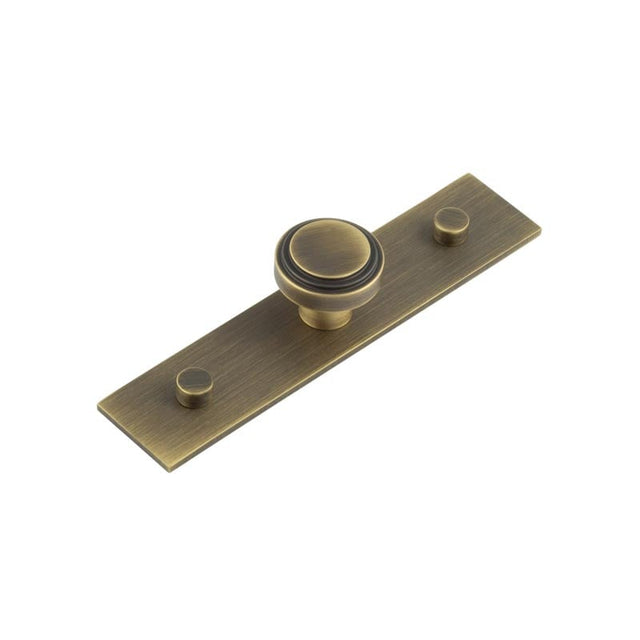 This is an image showing the Frelan - Cropley Cupboard Knobs 30mm Plain Backplate Antique Brass available to order from Trade Door Handles in Kendal