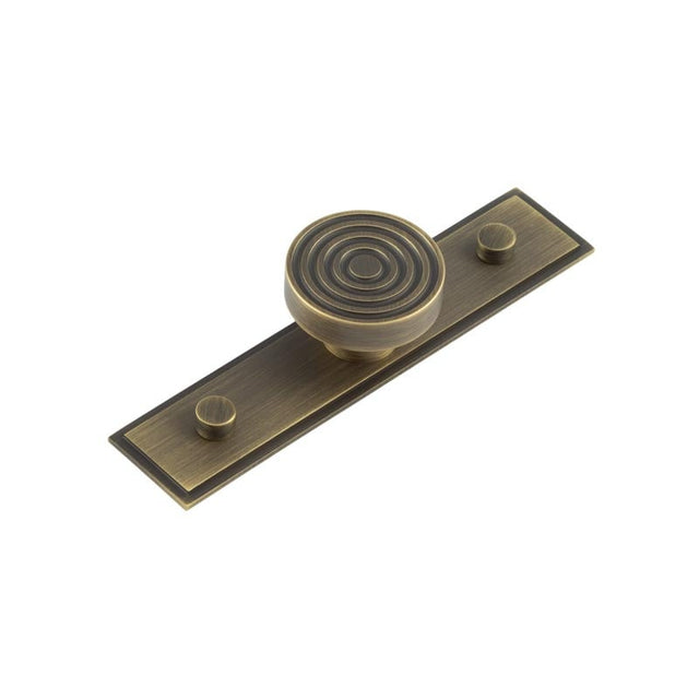 This is an image showing the Frelan - Murray Cupboard Knobs 40mm Stepped Backplate Antique Brass available to order from Trade Door Handles in Kendal