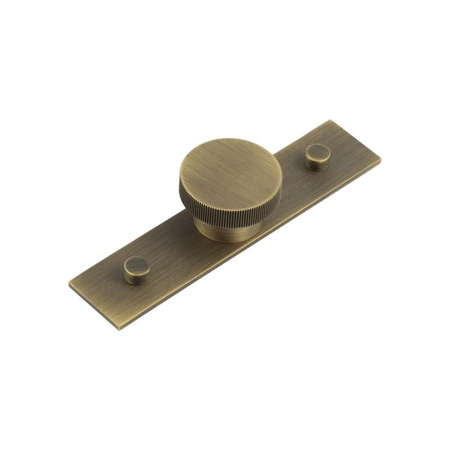 This is an image showing the Frelan - Thaxted Cupboard Knobs 40mm Plain Backplate Antique Brass available to order from Trade Door Handles in Kendal