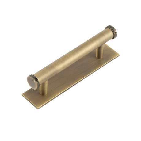 High quality image of Hoxton - Thaxted Cabinet Handles 96mm Ctrs Plain Backplate Antique Brass Sku. HOX-250AB-5050AB