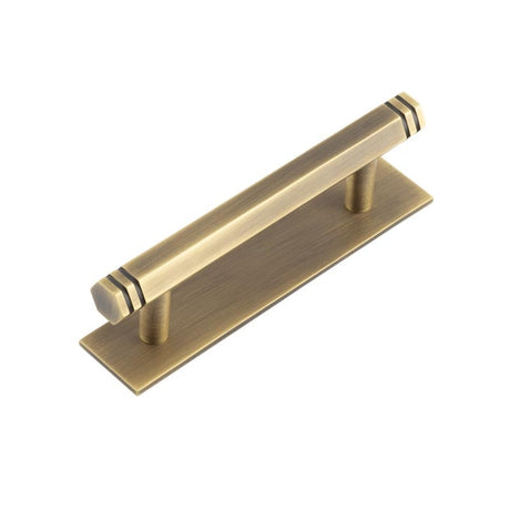 This is an image showing the Frelan - Hoxton Nile Cabinet Handles 96mm Ctrs Plain Backplate Antique Brass available to order from Trade Door Handles in Kendal