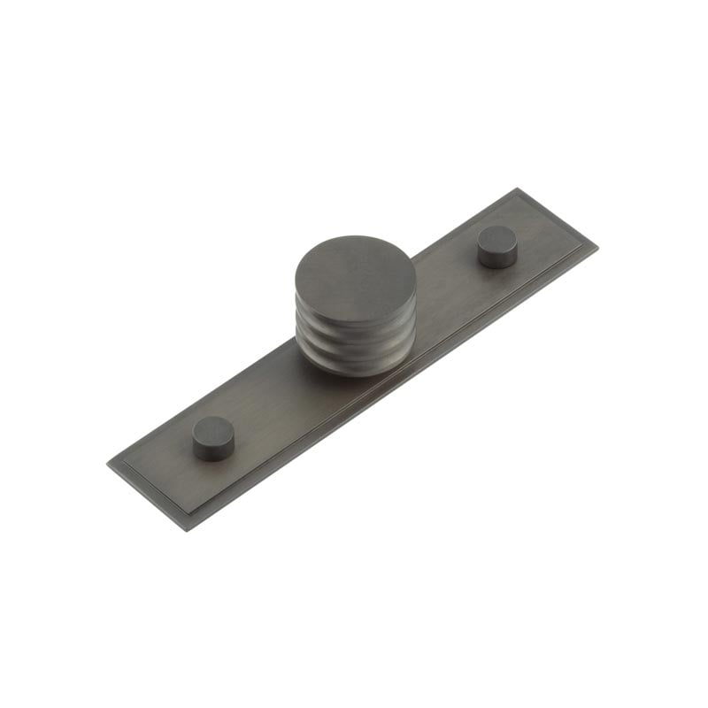 This is an image showing the Frelan - Sturt Cupboard Knobs 30mm Stepped Dark Bronze available to order from Trade Door Handles in Kendal