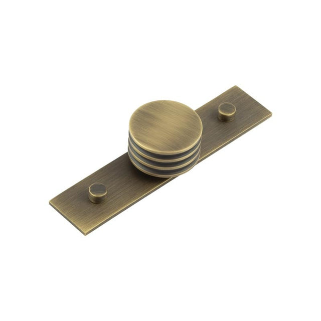 This is an image showing the Frelan - Sturt Cupboard Knobs 40mm Plain Antique Brass available to order from Trade Door Handles in Kendal