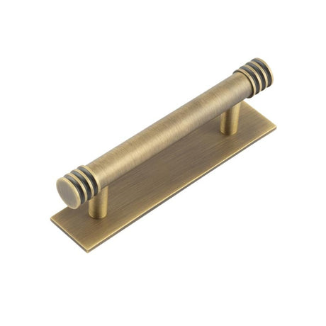 This is an image showing the Frelan - Hoxton Sturt Cabinet Handles 96mm Ctrs Plain Backplate Antique Brass available to order from Trade Door Handles in Kendal