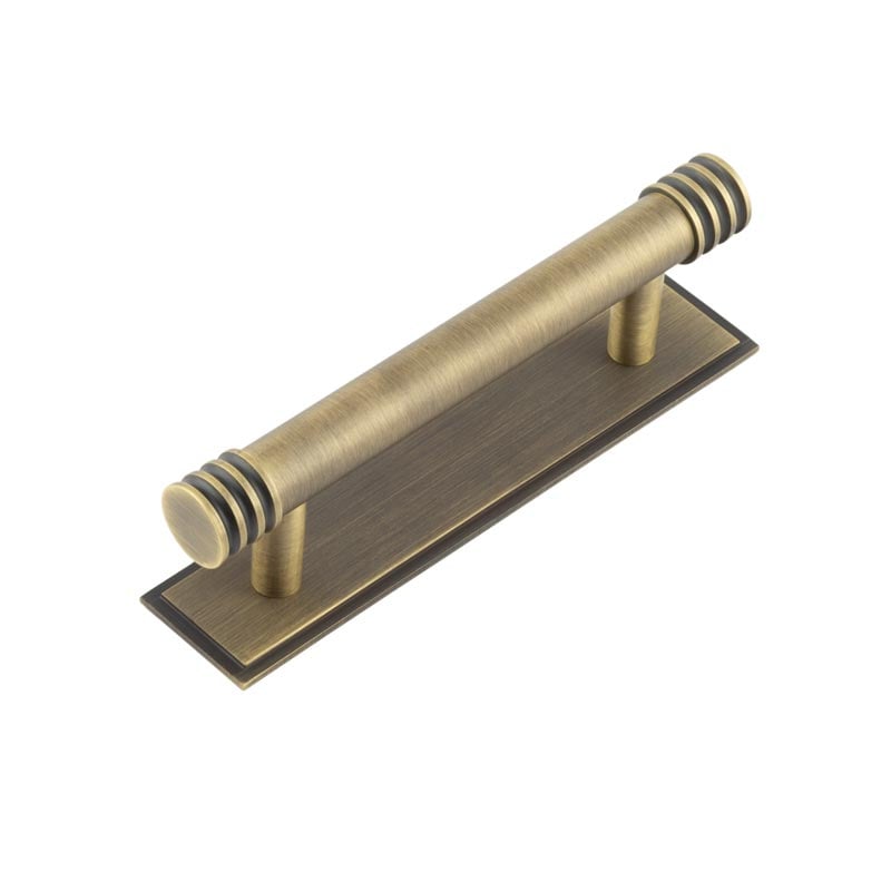 This is an image showing the Frelan - Hoxton Sturt Cabinet Handles 96mm Ctrs Stepped Backplate Antique Brass available to order from Trade Door Handles in Kendal