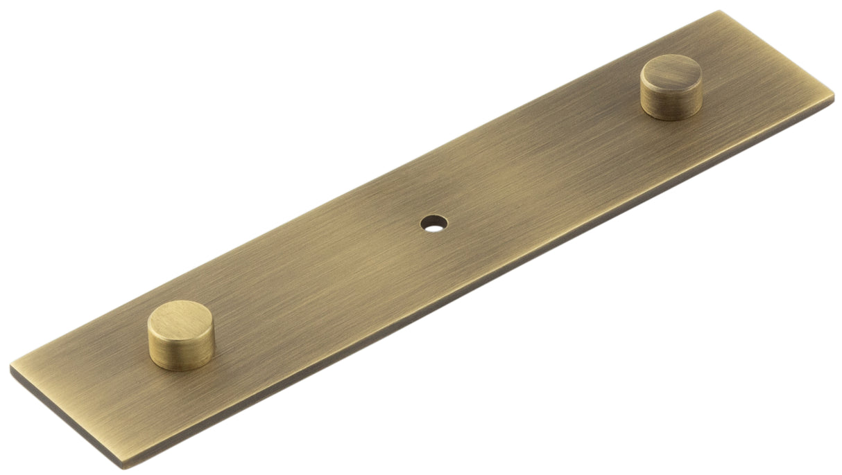 High quality image of Hoxton - Fanshaw Backplate for Cupboard Knobs 140x30mm Antique Brass Sku. HOX5090AB