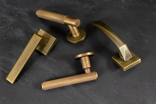 This is an image showing some brass door handles made by Atlantic Hardware