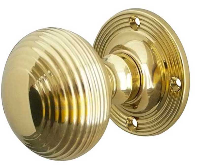 This is an image showing the Frelan - Reeded Unsprung Mortice Knobs - Polished Brass available to order from Trade Door Handles in Kendal