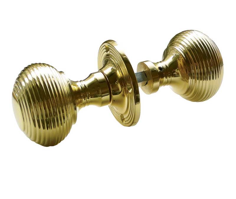 This is an image showing the Frelan - Reeded Unsprung Rim Knobs - Polished Brass available to order from Trade Door Handles in Kendal