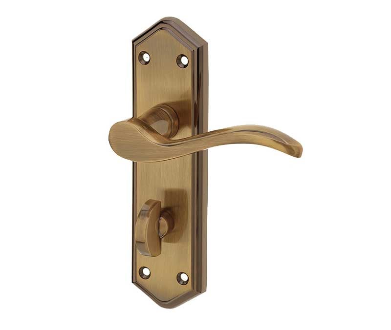 This is an image showing the Frelan - Paris Bathroom Lock Handles on Backplates - Antique Brass available to order from Trade Door Handles in Kendal