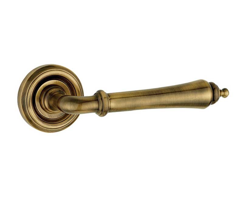 This is an image showing the Frelan - Camille Levers on Round Rose - Antique Brass available to order from Trade Door Handles in Kendal