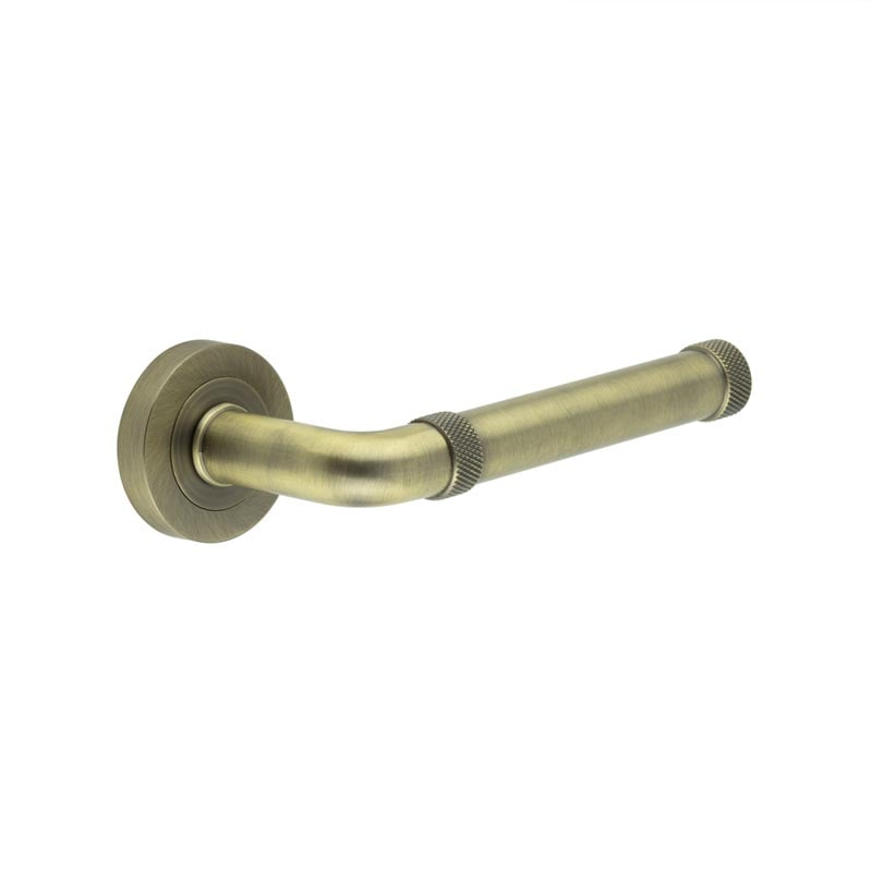 This is an image showing the Frelan - Midtown Antique Brass lever on rose available to order from Trade Door Handles in Kendal